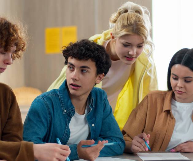 Four students friends girls females Caucasian boys guys males pupils sitting in school university college academy class talking argue discuss problem studying laptop learning prepare exams difficult. High quality 4k footage